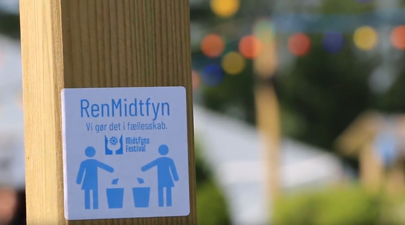 Picture of a sticker with two persons throwing out trash at the Midtfyn Festival.
